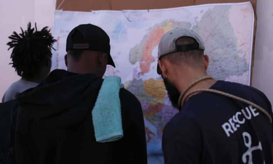 Men look at a map of Europe aboard the Ocean Viking.