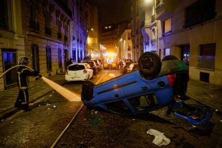 A vehicle turned upside down by demonstrators in Paris