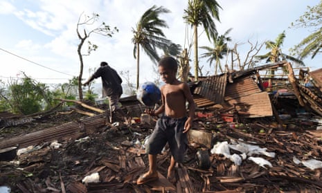 Port Vila residents search through the ruins of their home.