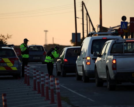 Police check vehicles on the road leading to RAF Akrotiri military base in Cyprus on Monday after the strike