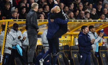 Pep Guardiola jumps into the arms of his assistant, Rodolfo Borrell.