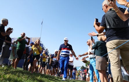 Koepka is greeted by spectators as he heads for a practice round