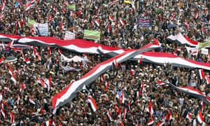 Thousands of Houthi supporters hold up Yemeni flags during a rally in Sana’a commemorating the second anniversary of the Saudi-led military campaign.