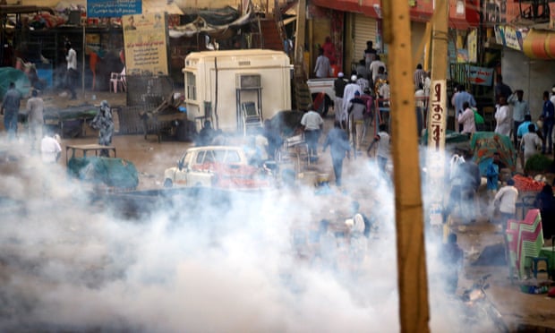 Smoke fills the air on a street in Khartoum after security forces use tear gas to disperse anti-government protesters