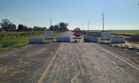 A road closed with several warning signs.