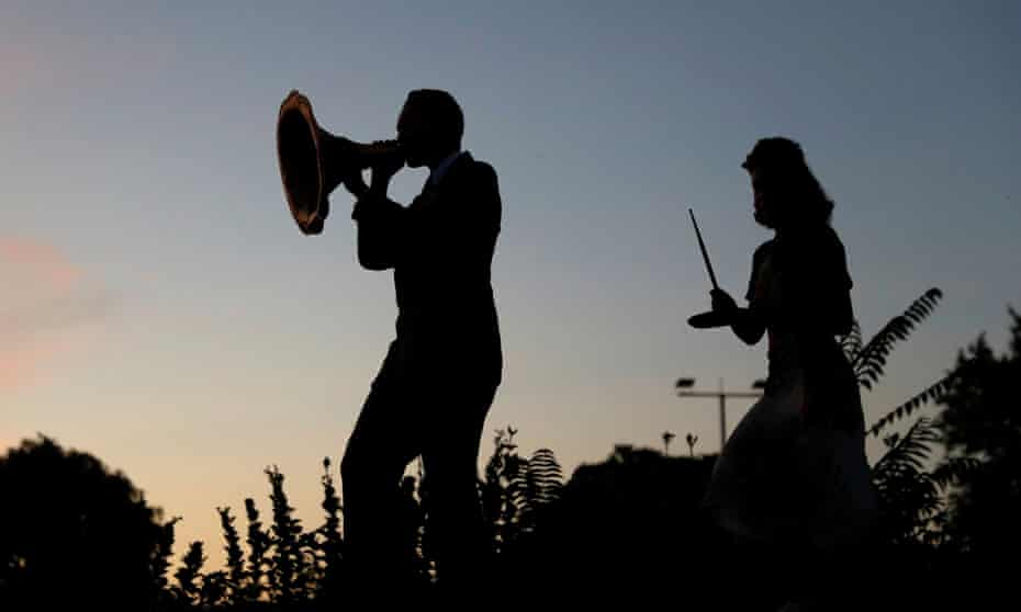 A swing band performs outside against a sunset