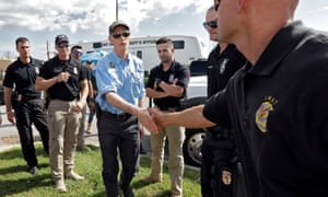 Governor Rick Scott, center, shakes hands with first responders brought in to help with Hurricane Michael relief on 11 October in Panama City Beach, Florida.