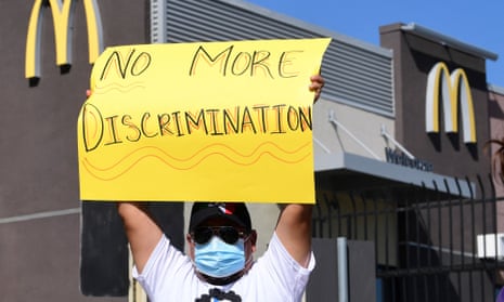 A McDonald’s employee holds a sign during a protest in Los Angeles, California, on 9 April. 