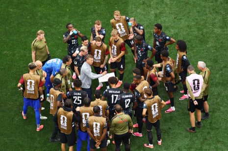 Canada coach Jesse Marsch speaks to his players during the hydration break.