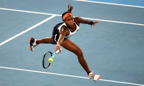 Coco Gauff volleys at the net during her second round match against Emma Raducanu.