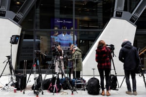 Members of the media gather outside the headquarters of the Premier League in London.