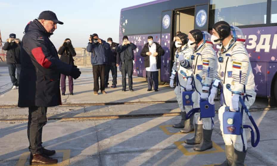 Dmitry Rogozin, the head of Roscosmos, left, speaks with Russian cosmonauts before their launch to the International Space Station (ISS), at the Baikonur Cosmodrome, in Kazakhstan on Friday.