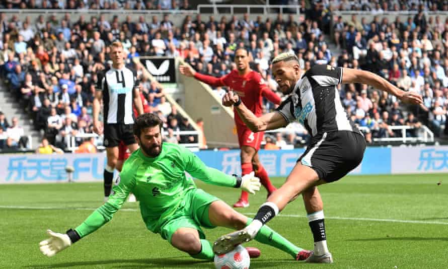 Joelinton of Newcastle United tries to get the ball past Liverpool's Alisson Becker in the Premier League match at St James' Park on 30 April 2022.