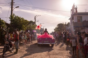 Pura rides around her neighbourhood in a pink 1950s convertible in Havana, Cuba.