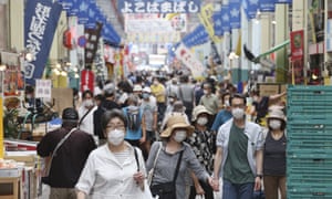 People wear face masks shop at a mall in Yokohama, near Tokyo as Japan’s prime minister Fumio Kishida says 80 million unused masks will be thrown away.