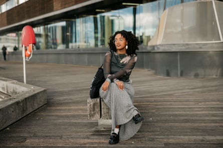 Girma sits on a boardwalk