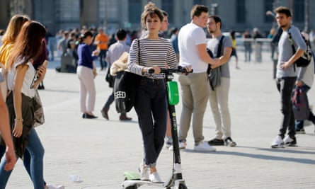 First Thing: Musk Offers General Amnesty To Suspended Twitter Accounts - The Guardian US 7 A person using an electric scooter among pedestrians in Paris