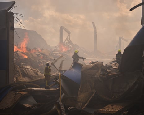 Firefighters try to extinguish a fire at a partially destroyed warehouse after a Russian drone attack in Brovary on the outskirts of Kyiv.