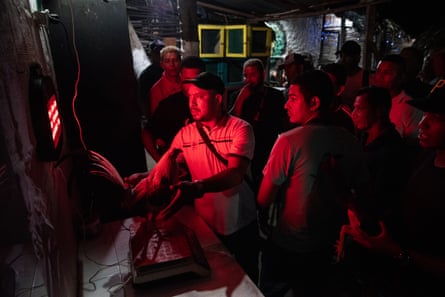 A group of people standing in red light