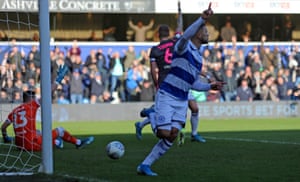 Nahki Wells, from QPR, celebrates after opening the scoring, while Leeds players complain about handball.