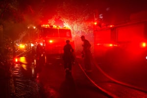 firefighters tackle a blaze at night
