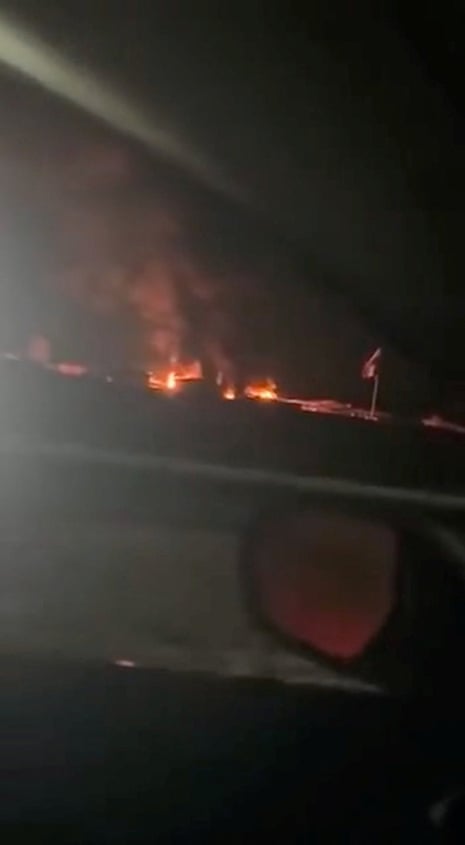 Fire and smoke rise after a reported drone attack at a military base in Makhmour, Erbil governorate, Iraq, in this screen grab obtained from a social media video today.