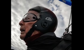 Man wearing goggles and helmet with sky in the background