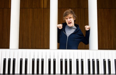 Internet sensation Bo Burnham standing above a giant piano keyboard