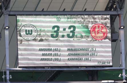 The scoreboard astatine Wolfsburg showing 3 goals scored successful added time.