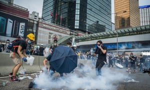 Protester try to use water to put out tear gas which the police used against them in Hong Kong