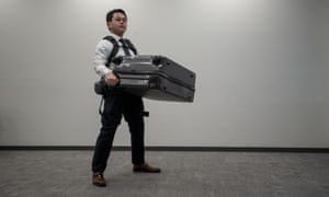 A man carries a suitcase using Panasonic’s Power Assist Suit ahead of the 2020 Games.