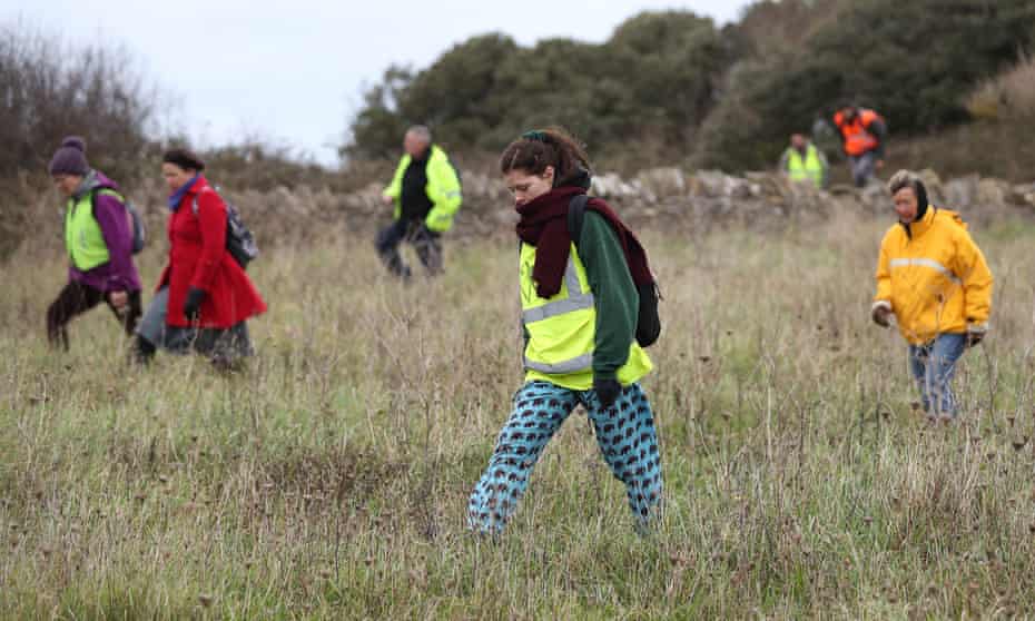 Members of the public looking for Gaia Pope in Durlston country park, Dorset.