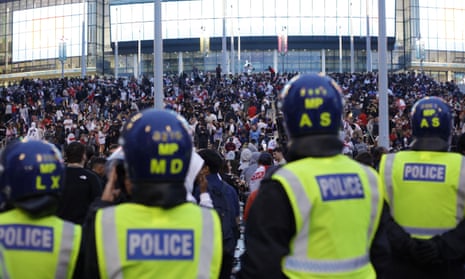 Police watch supporters outside Wembley Stadium