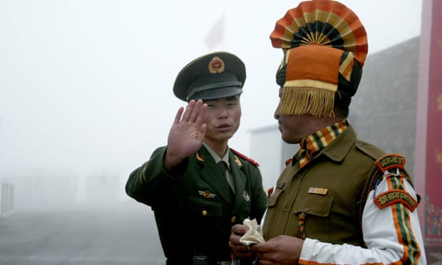 File photo of a Chinese soldier and Indian soldier at the Nathu La border crossing between India and China.