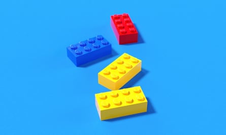 Two yellow, one blue and one red Lego bricks shot against a bright blue background