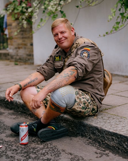 Dom sitting on a kerb with a can of beer at his feet