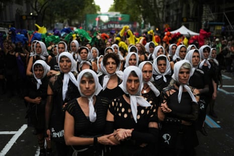 A group of women dressed in black and wearing white headscarves