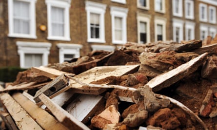 Victorian terrace houses and a skip filled with building materials