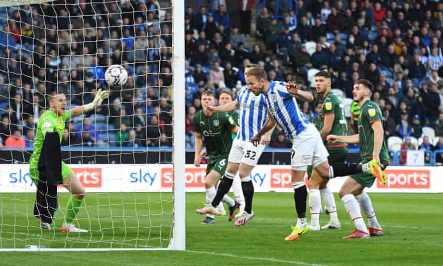 Barnsley relegated as Huddersfield seal playoff spot with victory | Championship 2 Jordan Rhodes heads Huddersfield into an early lead against Barnsley