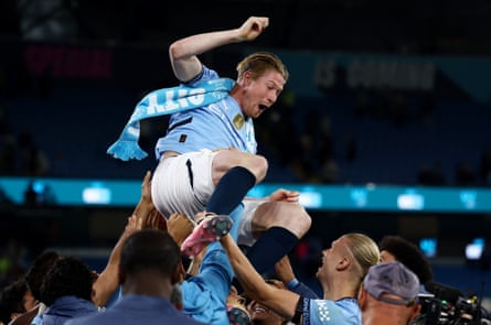 De Bruyne is thrown in the air by his City teammates.