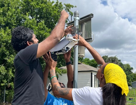 people set up a piece of equipment