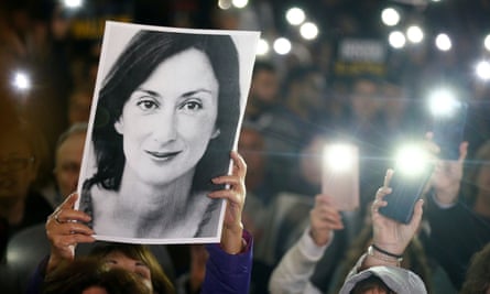 A photo of journalist Daphne Caruana Galizia is held aloft during a protest in Malta