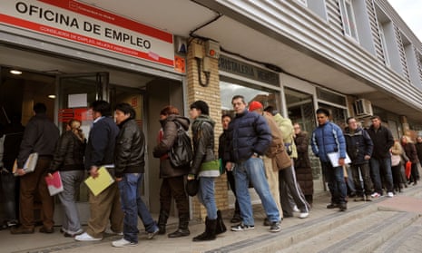 Jobseekers queue outside a state employment centre in Madrid