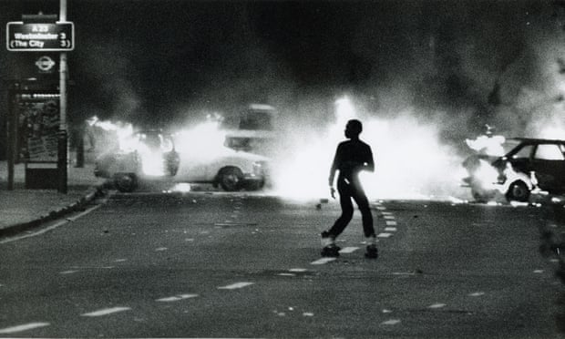 A young man amid the flames of the Brixton riots of 1981