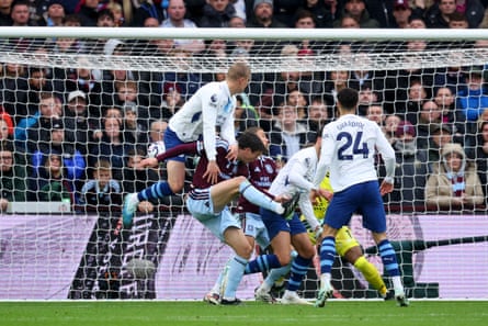 Erling Haaland scores for Manchester City, leaping above a crowd of players in the penalty area