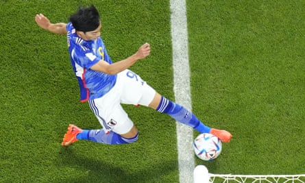 Japan's Kaoru Mitoma in the act of crossing the ball.