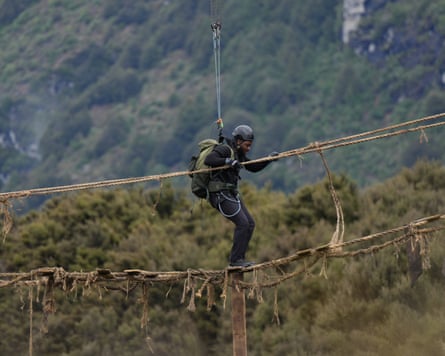 A person walking across a rope bridge