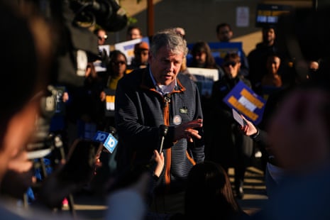 a man speaks to a crowd of people
