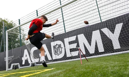 Liam Dineen, a kicker from Cork in Ireland, practices into a football goal during a training session for the NFL Academy at Loughborough University.