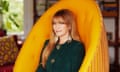 Jane Seymour sitting in a plush yellow gold cocoon chair